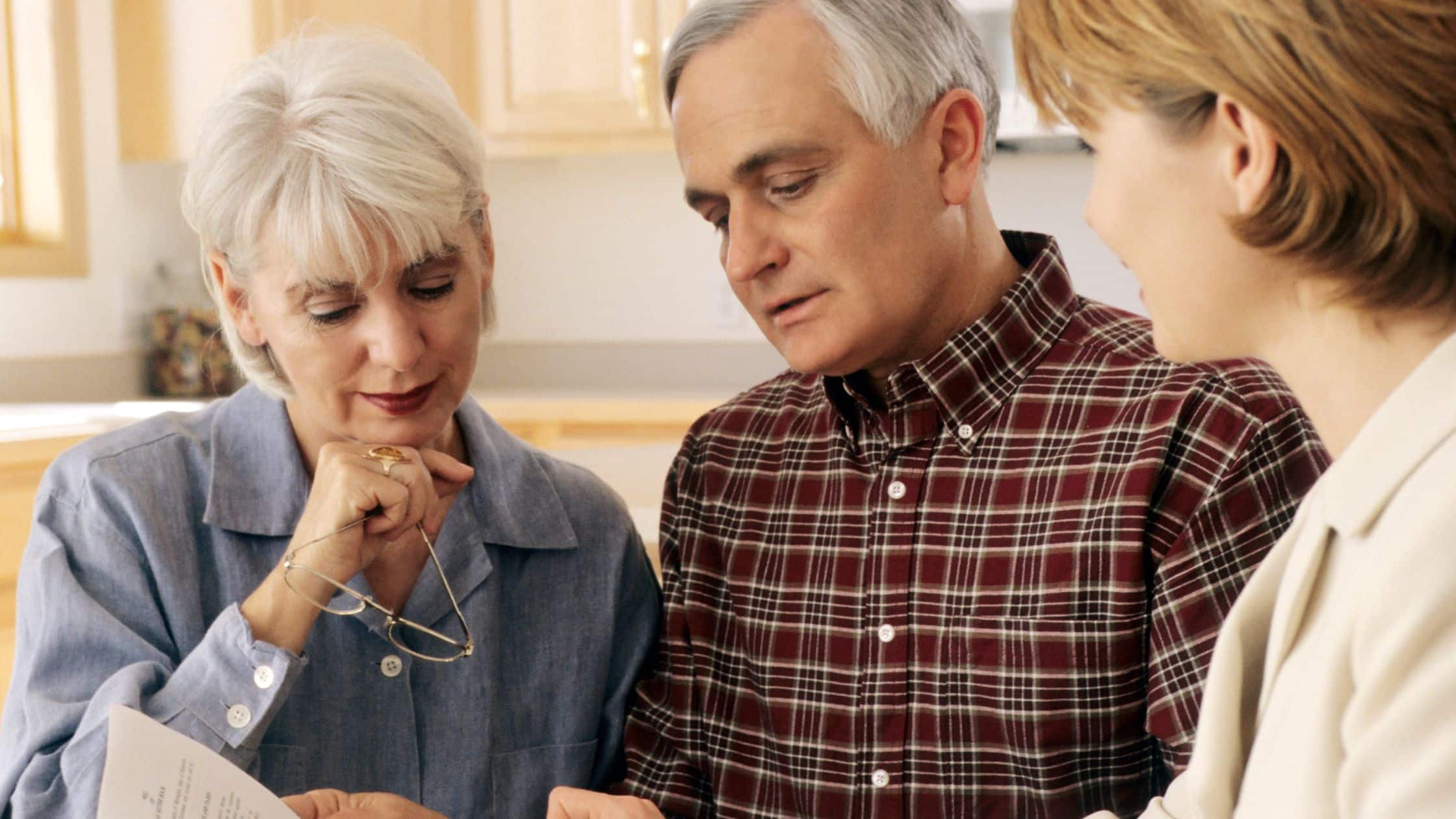 An older couple talking with their estate planning attorney, reviewing their options.