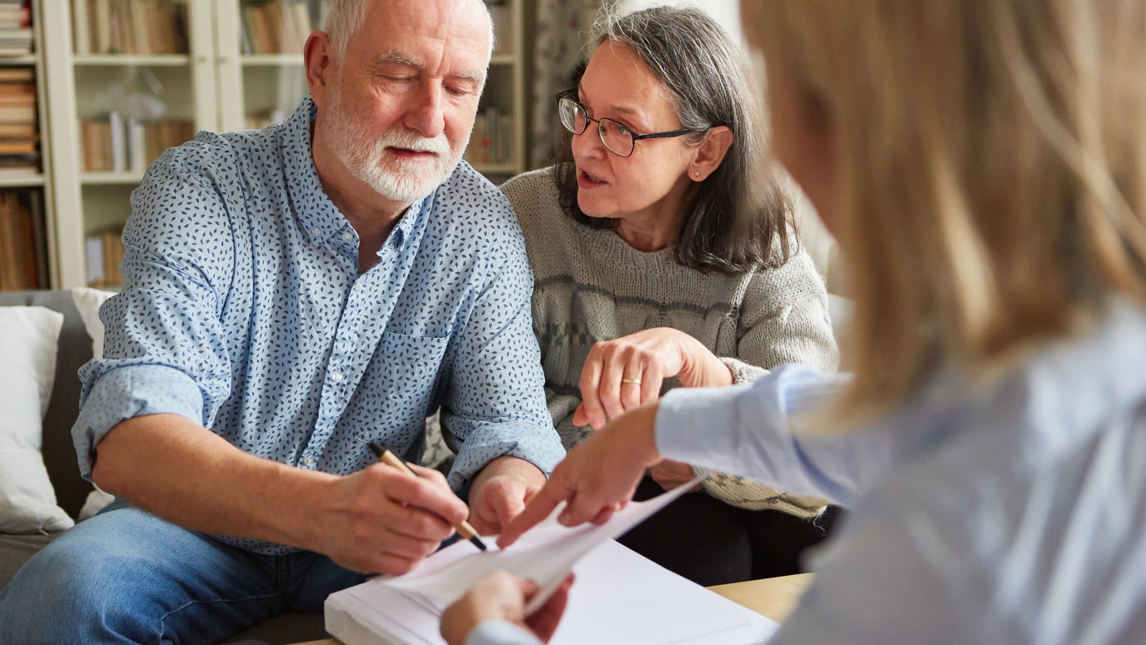 An elderly couple talking with an estate planning attorney about their needs.