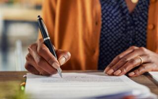 A woman working through financial paperwork.