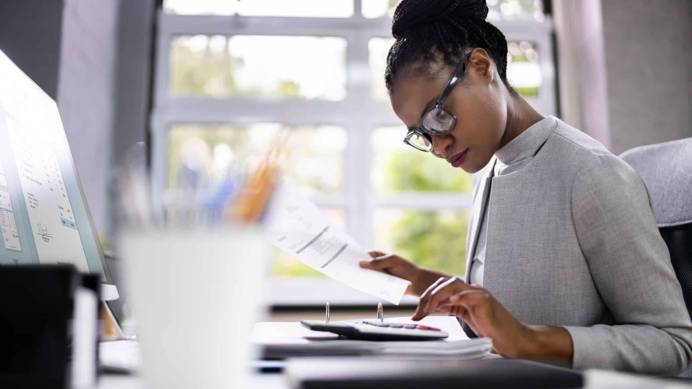 A woman working with a calculator.