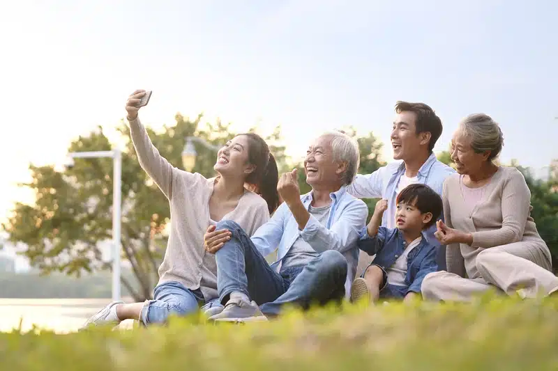 A multigenerational family posing outside for a picture.